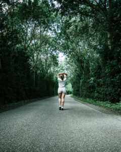 woman-in-white-t-shirt-walking-on-concrete-road-2792083_edited